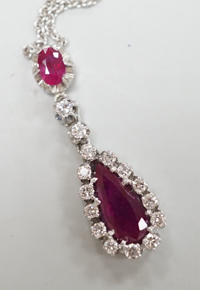 A modern 750 white metal, two stone ruby and fifteen stone diamond set pear shaped drop pendant necklace, pendant, 34mm, chain, 40cm, gross weight, 7.1 grams.